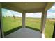 Covered patio offers serene views of the lush green landscape and beautiful blue sky at 4881 Vellacito Way, Davenport, FL 33897