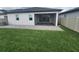 Beautiful backyard with green grass, screened lanai, and privacy fence at 4952 Shady Pines Dr, St Cloud, FL 34772