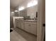 Modern bathroom featuring double vanity and large framed mirror at 4952 Shady Pines Dr, St Cloud, FL 34772