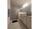 Well lit bathroom with white cabinets, dual sinks and walk-in shower at 4952 Shady Pines Dr, St Cloud, FL 34772