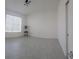 Bedroom with tiled floor, white walls, window with shades and a small table with plant at 4952 Shady Pines Dr, St Cloud, FL 34772