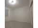 Empty bedroom with tile floors, a window, closet, and white walls at 4952 Shady Pines Dr, St Cloud, FL 34772
