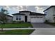 Beautiful single-story home featuring a modern design, manicured lawn, and attached two-car garage at 4952 Shady Pines Dr, St Cloud, FL 34772