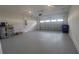 Spacious garage with painted floors and high ceilings ready for storage and vehicles at 4952 Shady Pines Dr, St Cloud, FL 34772