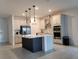 Bright kitchen with stainless steel appliances, island with breakfast bar, and modern pendant lighting at 4952 Shady Pines Dr, St Cloud, FL 34772