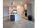 Bright open-concept kitchen with stainless steel appliances, island with breakfast bar, and tile flooring at 4952 Shady Pines Dr, St Cloud, FL 34772