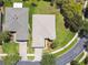 An aerial view of a beautiful home with a manicured lawn, a two-car garage, and lush landscaping at 531 Barcelona Dr, Poinciana, FL 34759