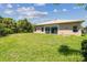 Beautiful backyard with lush green grass and mature landscaping at 531 Barcelona Dr, Poinciana, FL 34759
