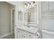 Bathroom featuring a sleek vanity with a decorative mirror and plenty of storage at 531 Barcelona Dr, Poinciana, FL 34759