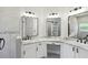 Bathroom featuring dual vanities, undermount sinks, granite counters, and modern fixtures and hardware at 531 Barcelona Dr, Poinciana, FL 34759