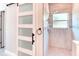 Bathroom view featuring tiled shower, glass barn door, and modern finishes at 531 Barcelona Dr, Poinciana, FL 34759