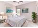 This staged bedroom has a bed, two nightstands, artwork, and a plant at 531 Barcelona Dr, Poinciana, FL 34759