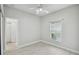 This is a bright bedroom with a ceiling fan, tile floors and natural light from the window at 531 Barcelona Dr, Poinciana, FL 34759