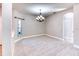 Open-concept dining area with tiled floors, chandelier lighting and an archway that peeks into the kitchen at 531 Barcelona Dr, Poinciana, FL 34759