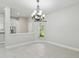 Bright dining area with tile floors, modern chandelier, and a view of the kitchen at 531 Barcelona Dr, Poinciana, FL 34759