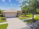 Charming one-story home with a brick driveway, attached garage and mature landscaping at 531 Barcelona Dr, Poinciana, FL 34759