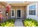 Open front door invites you into this beautifully landscaped home with decorative plants and a brick walkway at 531 Barcelona Dr, Poinciana, FL 34759