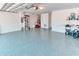 Spacious garage with painted walls, sealed floor and storage shelves at 531 Barcelona Dr, Poinciana, FL 34759
