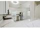 Modern kitchen with white cabinets, stainless steel appliances, and a spacious marble countertop at 531 Barcelona Dr, Poinciana, FL 34759