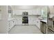 Elegant kitchen showcasing white cabinets, stainless steel appliances, and marble countertops at 531 Barcelona Dr, Poinciana, FL 34759