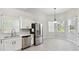 Bright kitchen featuring stainless steel appliances, marble countertops, and contemporary white cabinetry at 531 Barcelona Dr, Poinciana, FL 34759