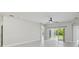Bright living room features tile floors, neutral paint, modern ceiling fan, and sliding glass doors at 531 Barcelona Dr, Poinciana, FL 34759