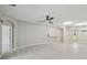 Spacious and airy living room with tile floors, neutral walls, and a modern ceiling fan at 531 Barcelona Dr, Poinciana, FL 34759