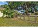 Lovely backyard view featuring a wooden and wire gate with surrounding greenery and shade trees at 541 Rebecca Dr, St Cloud, FL 34769