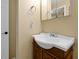Bathroom with wood vanity and large sink, updated faucet and light fixture at 541 Rebecca Dr, St Cloud, FL 34769