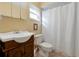 Bathroom with wood vanity, tile flooring, and a shower with a curtain at 541 Rebecca Dr, St Cloud, FL 34769