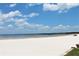 Beautiful beach with clear water, white sand, and a blue sky with puffy white clouds at 541 Rebecca Dr, St Cloud, FL 34769