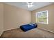 Bedroom with a window view, ceiling fan, and neutral colored walls and carpet at 541 Rebecca Dr, St Cloud, FL 34769