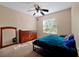 Spacious bedroom featuring a ceiling fan, large window, and mirrored dresser at 541 Rebecca Dr, St Cloud, FL 34769