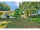 Home exterior with lush trees and a shed in the backyard, blending comfort and outdoor charm at 541 Rebecca Dr, St Cloud, FL 34769
