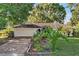 Charming single-story home with a well-maintained lawn and colorful landscaping at 541 Rebecca Dr, St Cloud, FL 34769