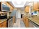 Well-lit kitchen with stainless steel appliances, granite countertops, and light wood cabinetry for a modern look at 541 Rebecca Dr, St Cloud, FL 34769