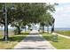 Scenic view of a park walkway leading to the waterfront and a covered pavilion at 541 Rebecca Dr, St Cloud, FL 34769