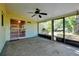 View of the patio, screened-in with a ceiling fan and access to both the house interior and outdoor living space at 541 Rebecca Dr, St Cloud, FL 34769