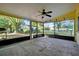 Enjoy the screened patio featuring a ceiling fan overlooking the landscaped backyard of this home at 541 Rebecca Dr, St Cloud, FL 34769