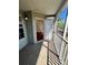 Balcony leading into unit, with wood floors, and view of building exterior through screen at 6148 Westgate Dr # 302, Orlando, FL 32835