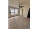 Bedroom with carpet, ceiling fan, built-in shelving, and two large windows for natural light at 6148 Westgate Dr # 302, Orlando, FL 32835
