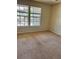 Bedroom featuring two large windows, offering ample natural light and a pleasant view at 6148 Westgate Dr # 302, Orlando, FL 32835