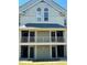 Close up of exterior of a two-story condo featuring neutral tone paint and double stairways and balconies at 6148 Westgate Dr # 302, Orlando, FL 32835