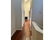 Hallway leading to living room with fireplace and hardwood floors at 6148 Westgate Dr # 302, Orlando, FL 32835