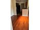Living room with wood flooring, neutral walls, and a partial view of the kitchen at 6148 Westgate Dr # 302, Orlando, FL 32835