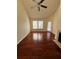 Open living room with hardwood floors, ceiling fan, fireplace, and view to outdoor balcony at 6148 Westgate Dr # 302, Orlando, FL 32835