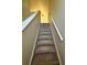 Carpeted staircase with white railing provides access to upper level at 6148 Westgate Dr # 302, Orlando, FL 32835