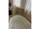 Clean bathroom featuring a large bathtub with tile surround and a chrome faucet at 619 Tapatio Ln, Kissimmee, FL 34759