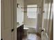Bathroom features a shower-tub combo, toilet, vanity, and window for natural light at 619 Tapatio Ln, Kissimmee, FL 34759