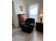 Bedroom features an armchair, hard wood flooring, and a view of the window at 619 Tapatio Ln, Kissimmee, FL 34759
